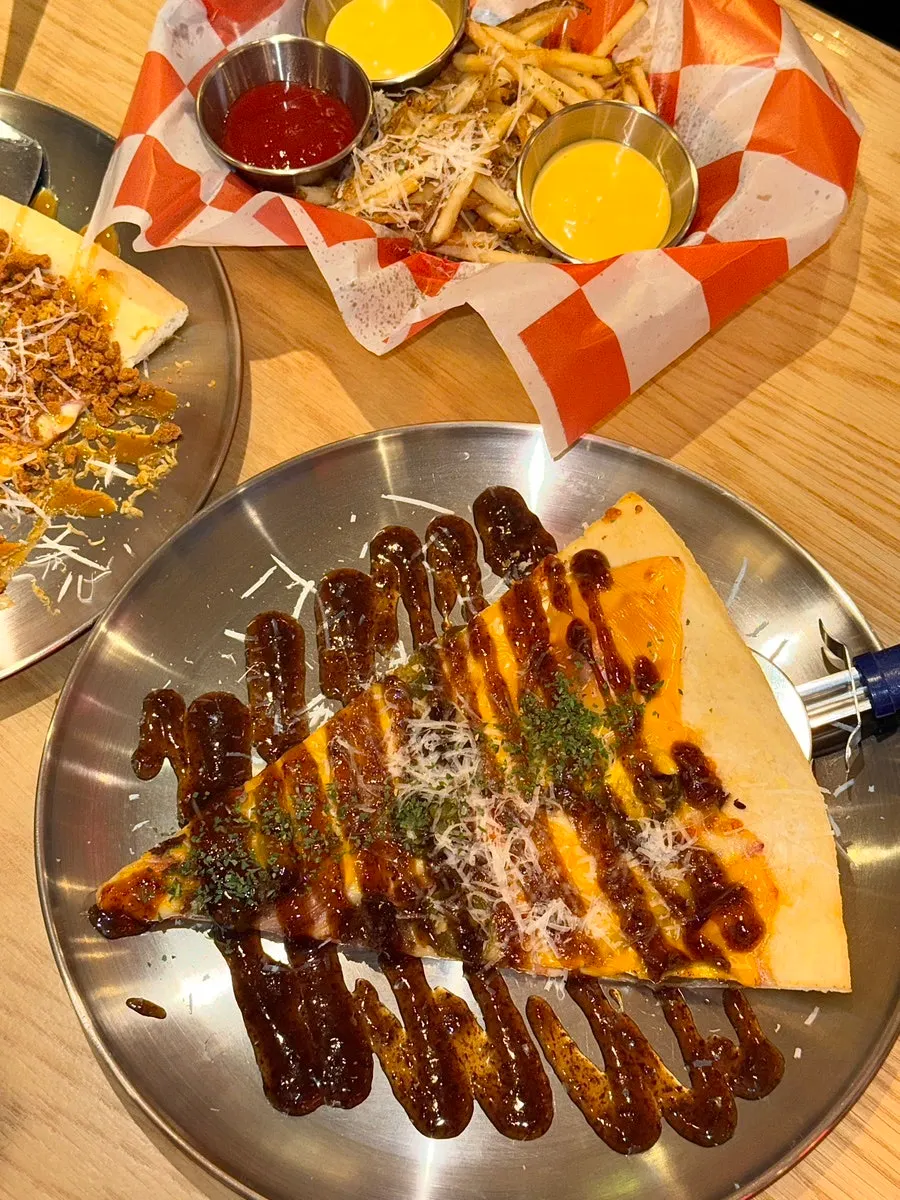 A slice of American Bulbeok Pizza the size of a face