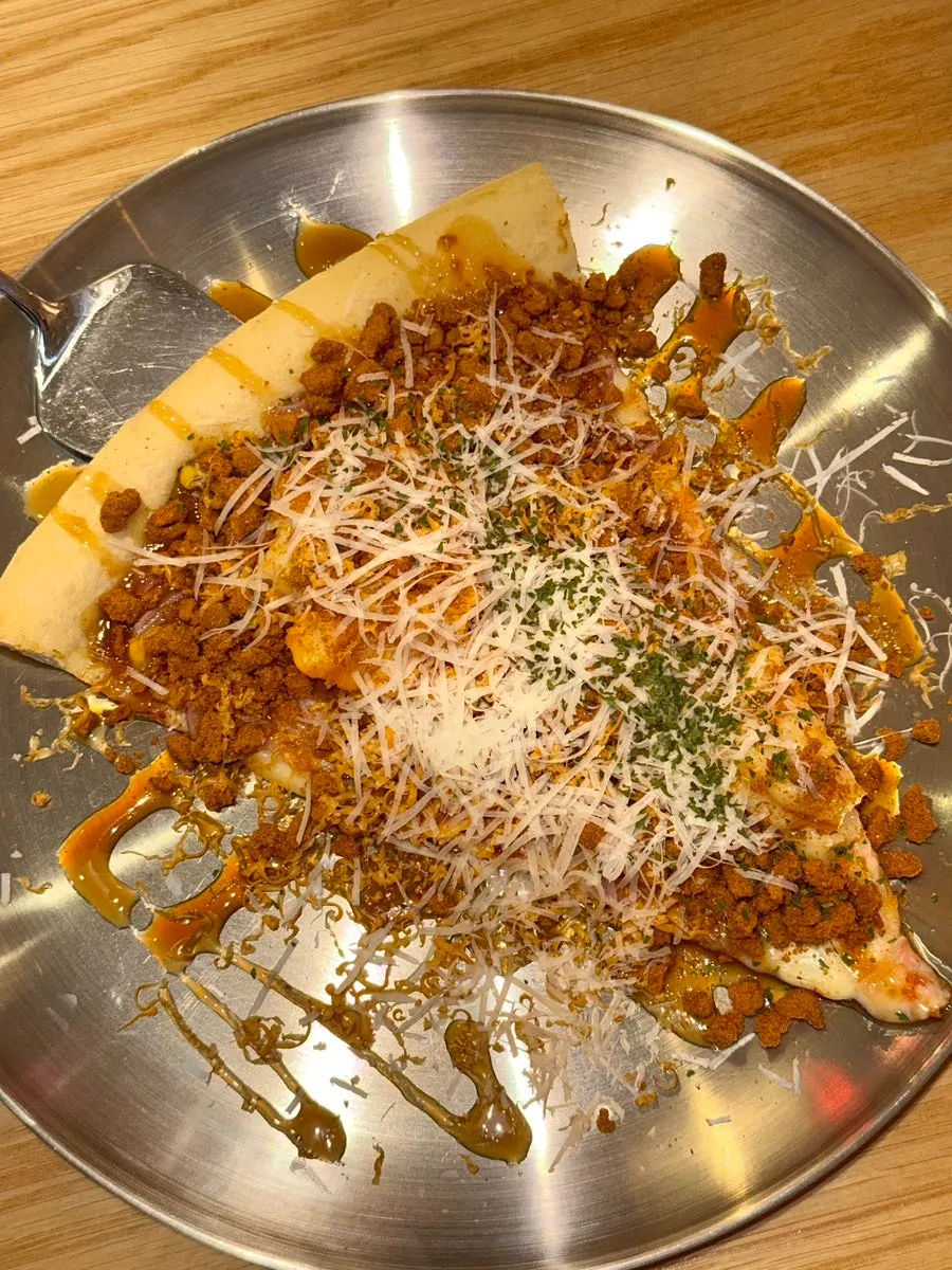 A slice of Brown Potato Pizza (Lotus)