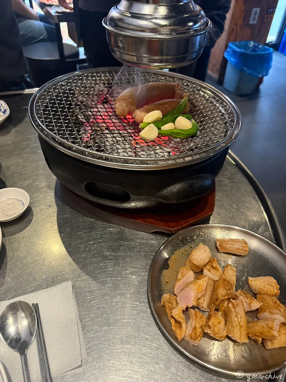 Two servings of grilled yang-daechang cooking on the grill