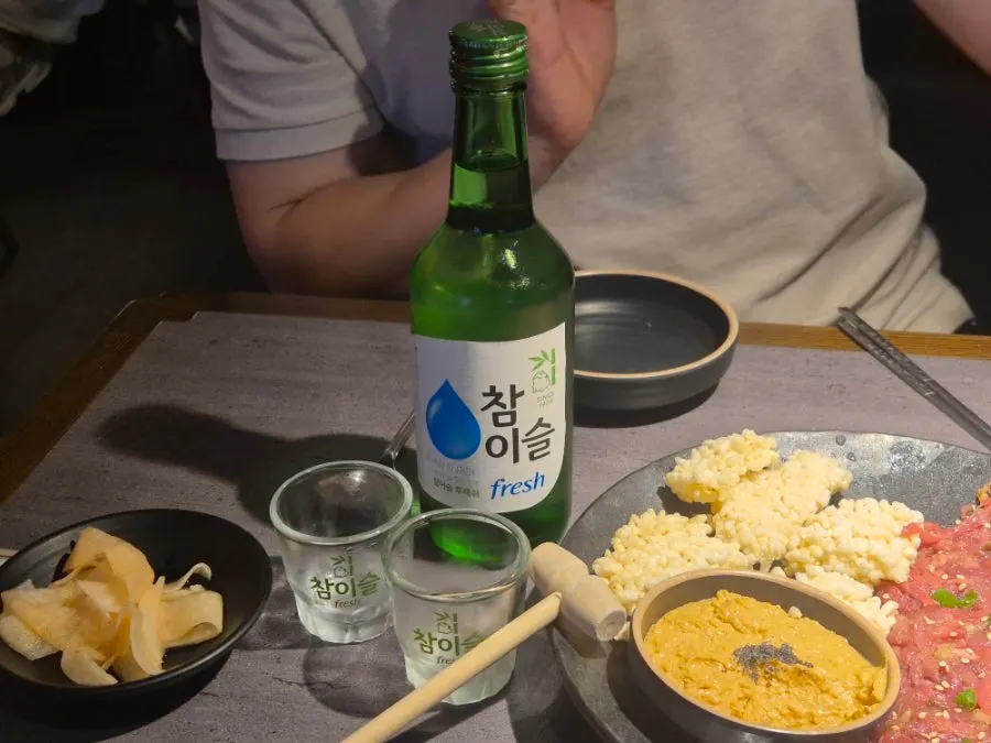 A bite of burnt rice topped with yukhoe and monkfish liver