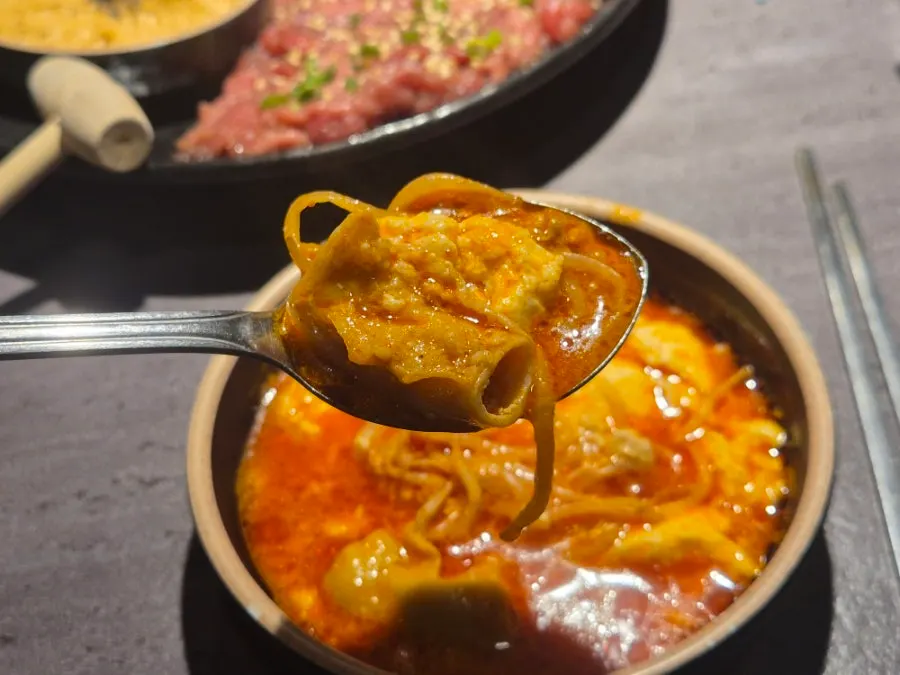 Tripe and soft tofu broth served into a small plate