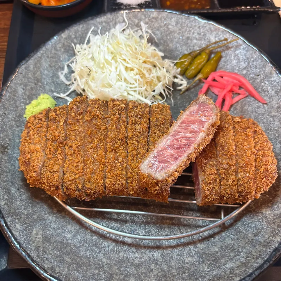 A piece of gyukatsu paired with salt and wasabi