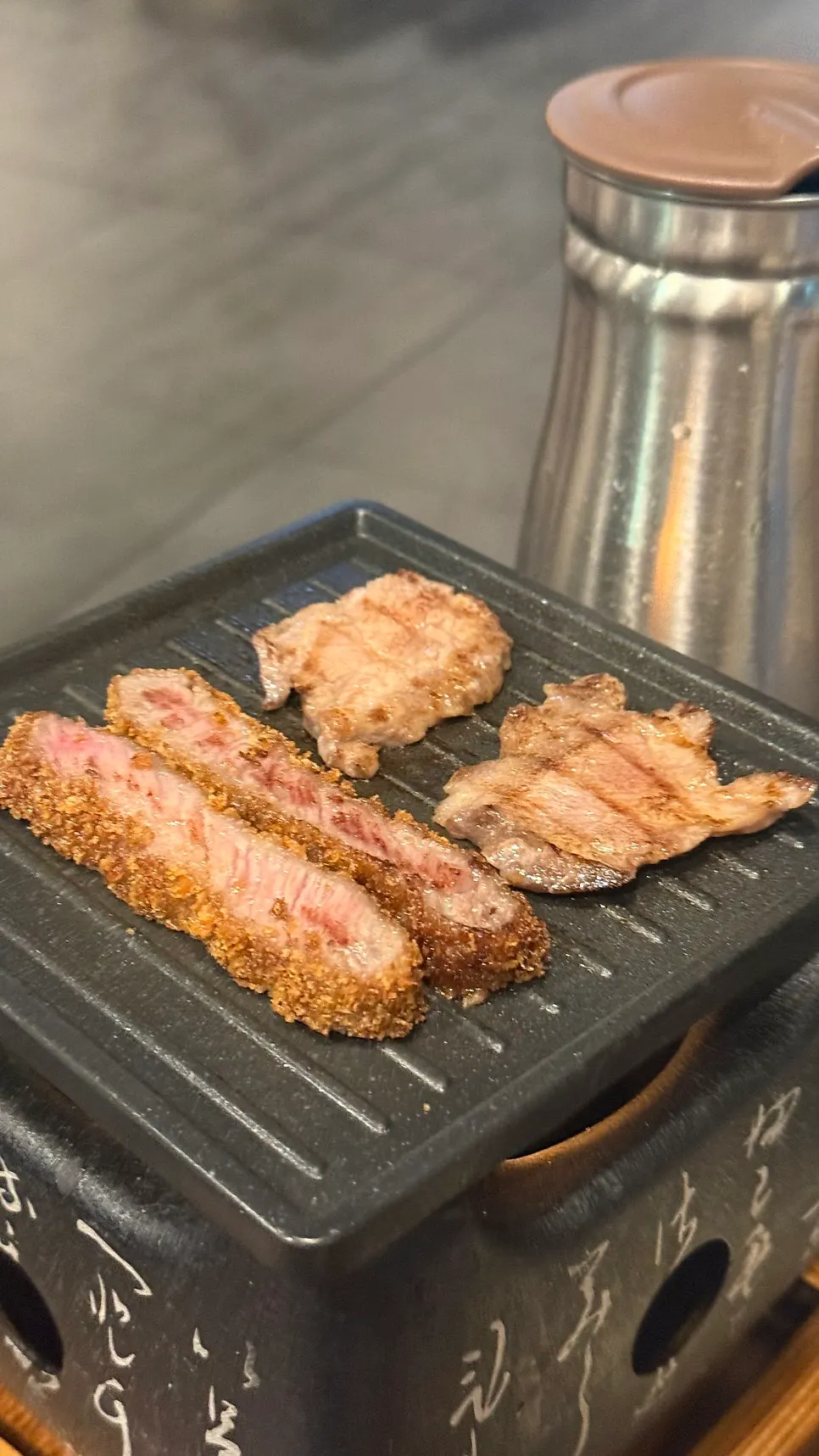 Meat grilling to a golden brown on the tabletop grill