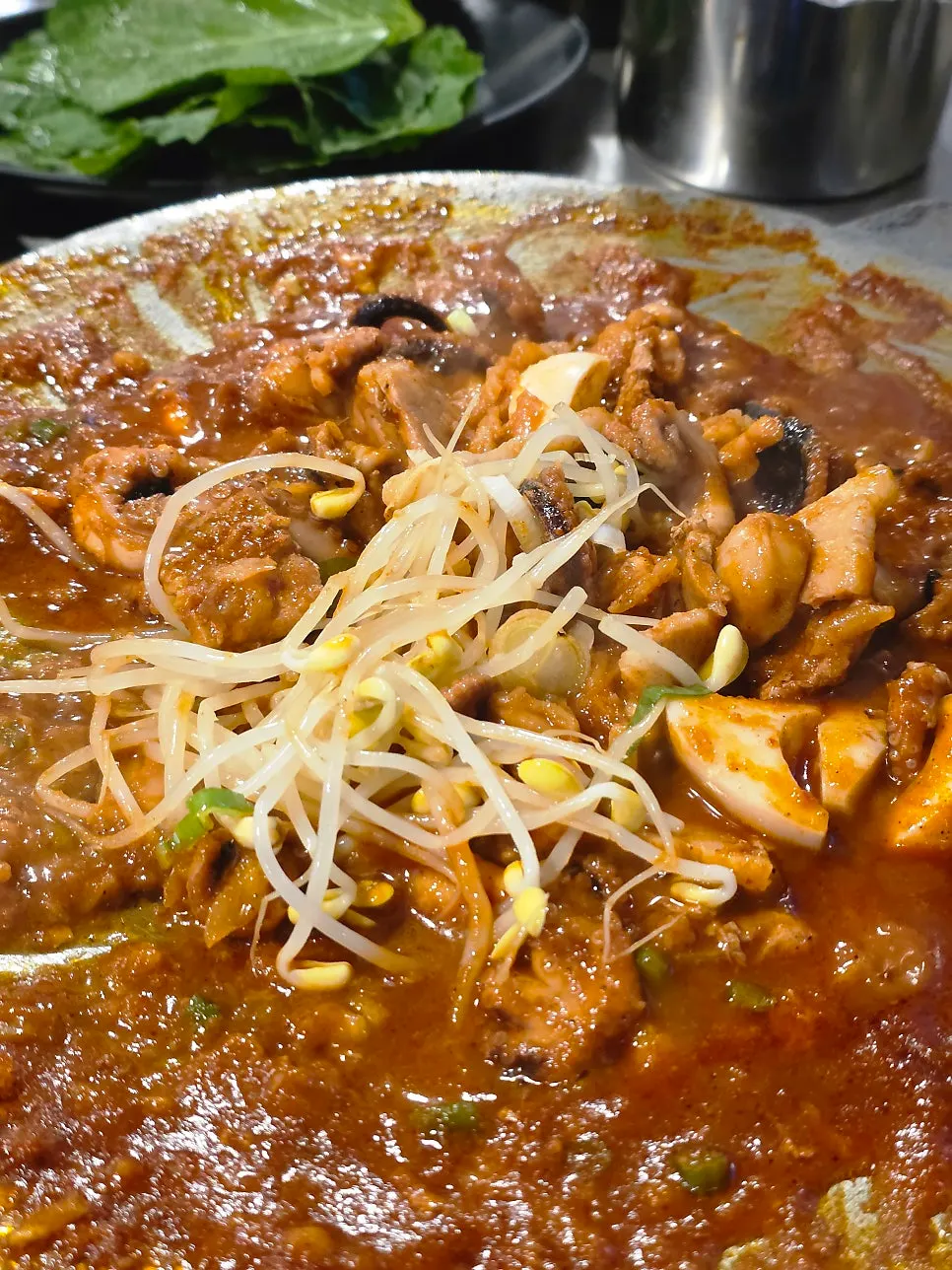 Hot plate octopus and pork belly topped with bean sprouts