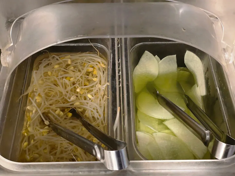 Mayo sauce, ssamjang, and other side dishes at the self-serve bar