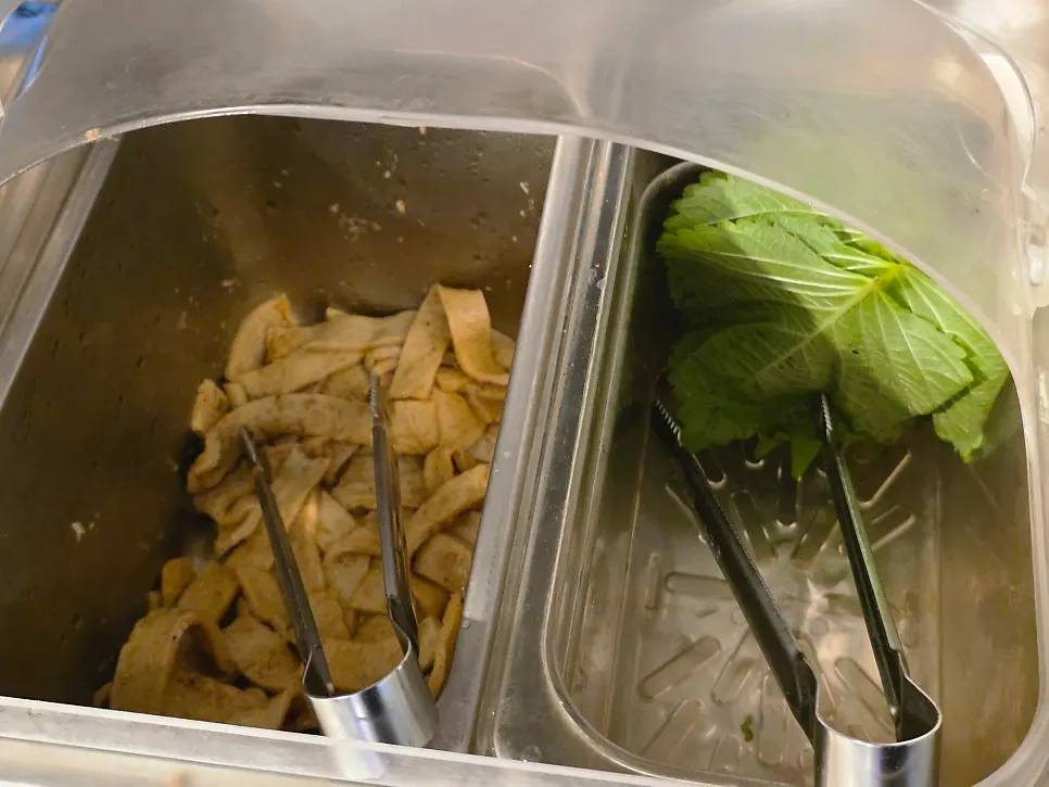 Pickled radish, fish cake, and perilla leaves at the self-serve bar