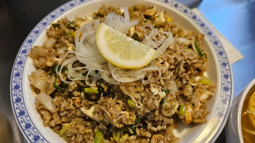 Close-up of mixed pho broth and noodles