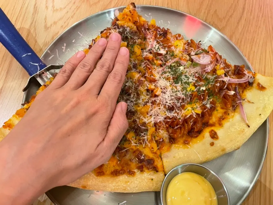 Two pizza slices with added garlic sauce