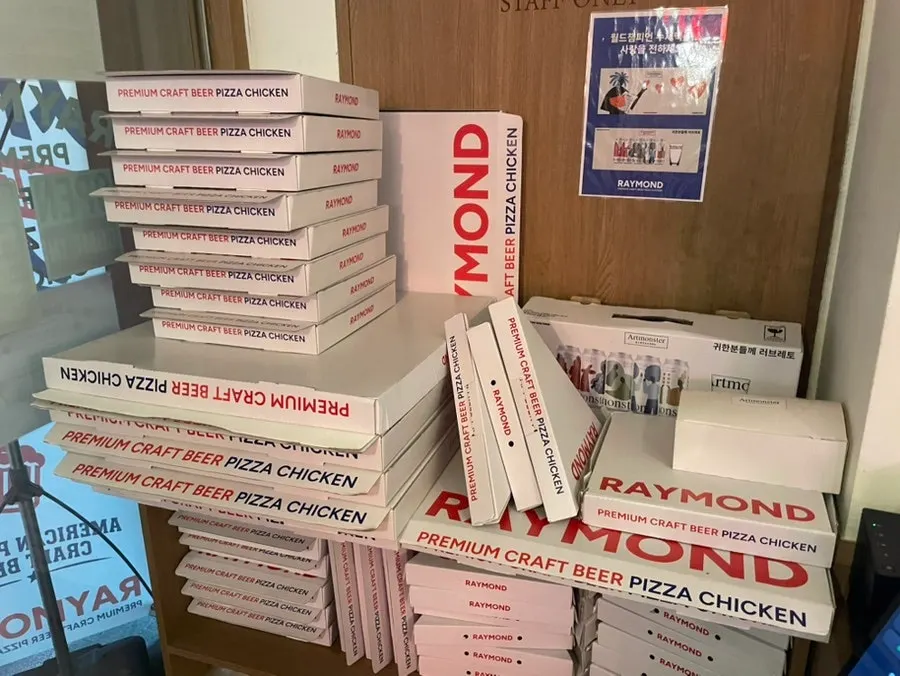 Table spread with tangy pickles, pizza, and chicken