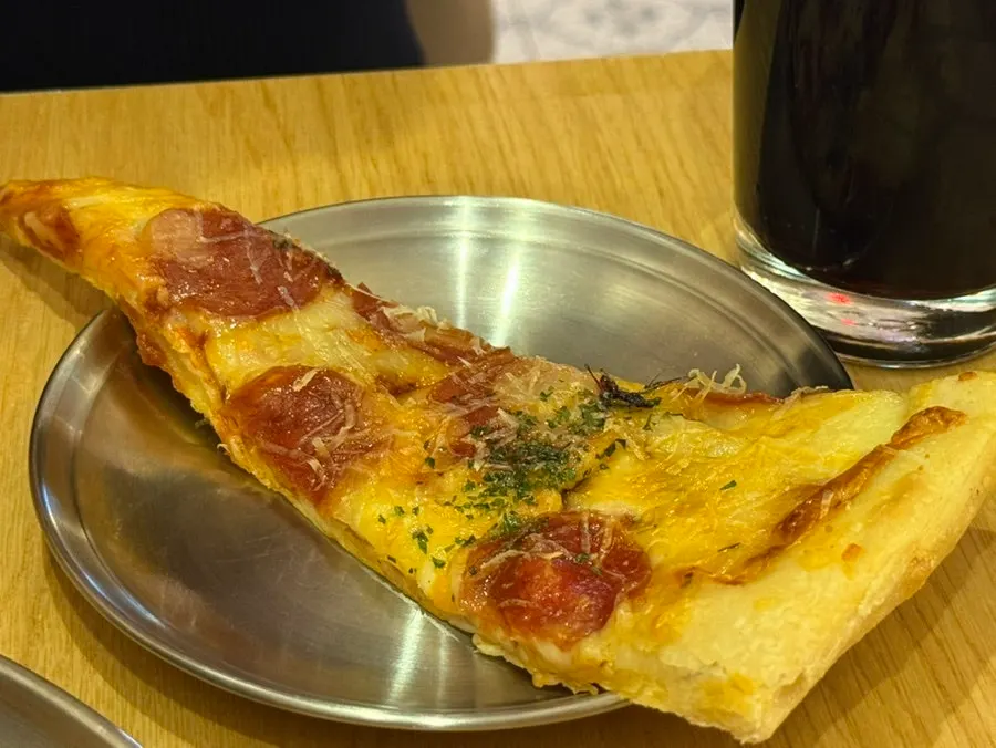 A slice of Raymond's pepperoni pizza