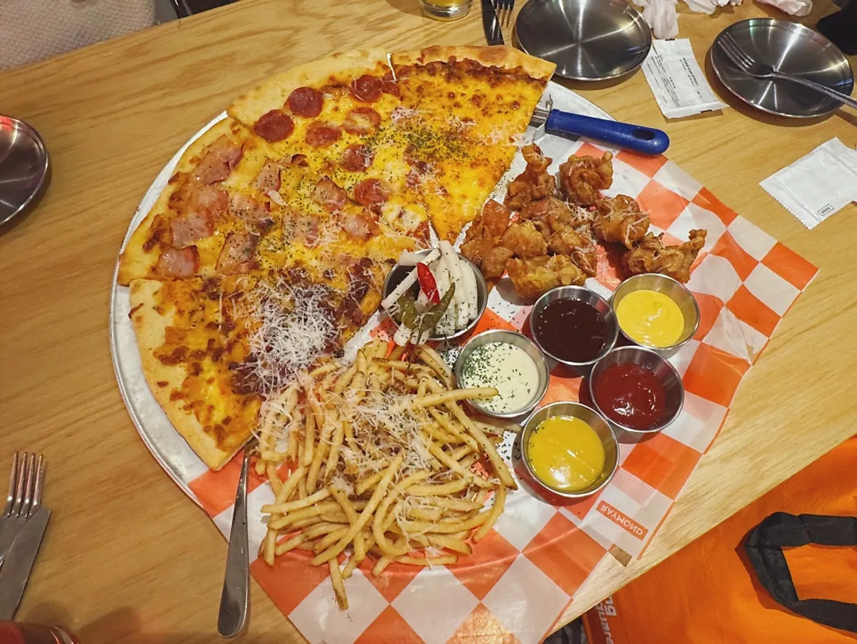 Self-service corner with water, hot sauce, and utensils