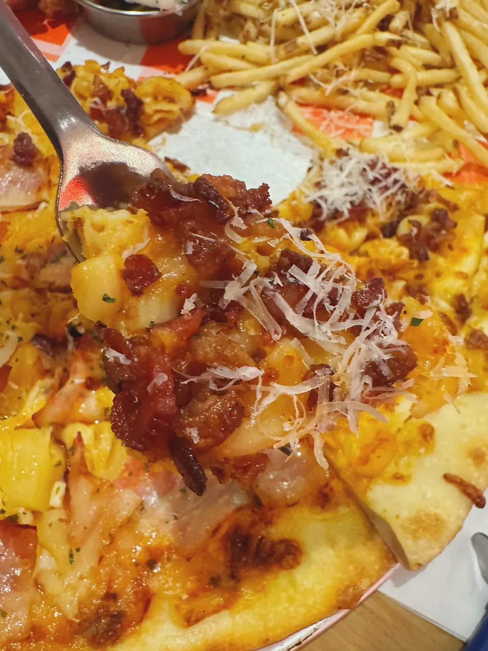 Mac and cheese slice pizza topped with macaroni