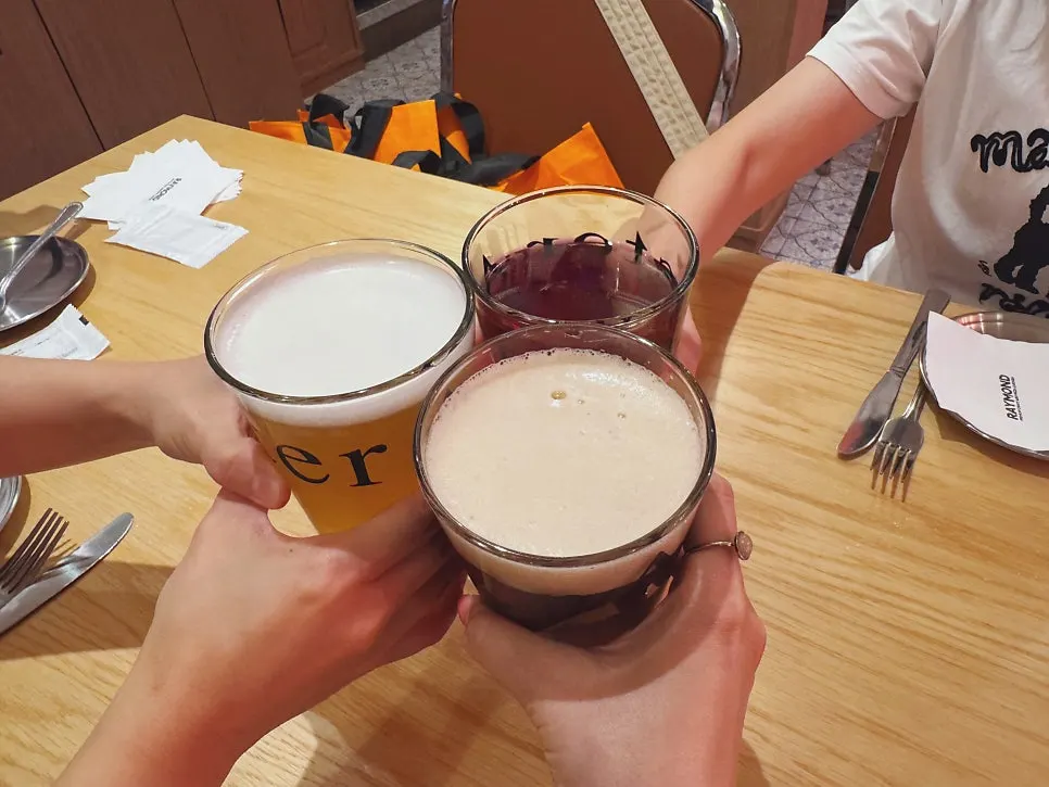Three craft beers set on the table with pizza