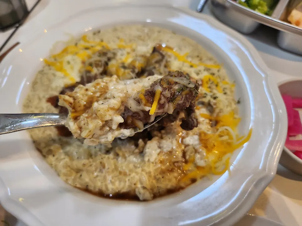 A spoonful of risotto soaked in cream sauce