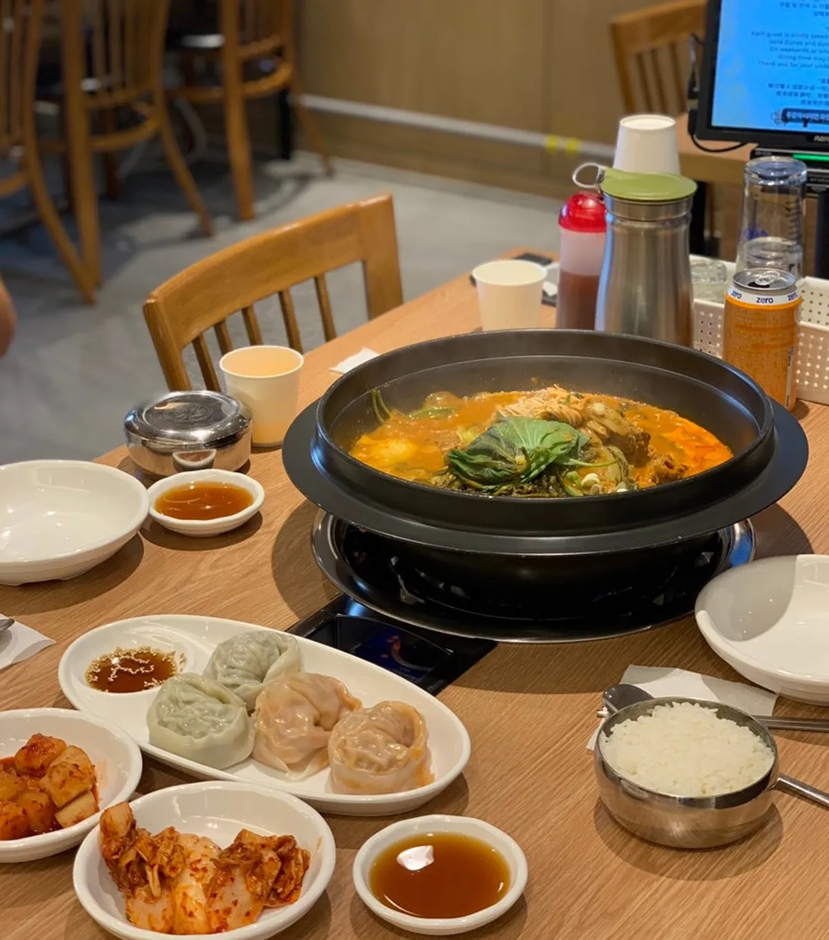 Full spread of Medium gamjatang and king mandu half-and-half