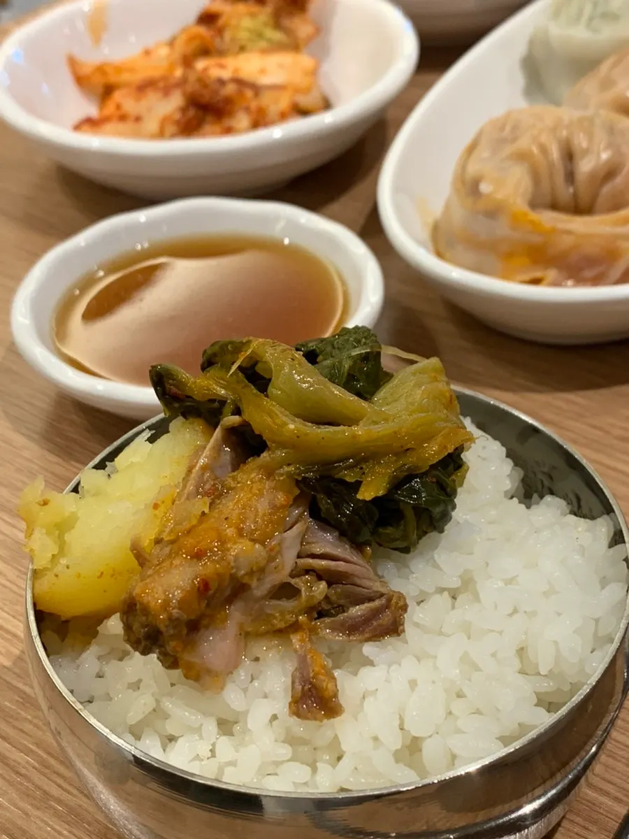 Rich gamjatang broth loaded with radish greens