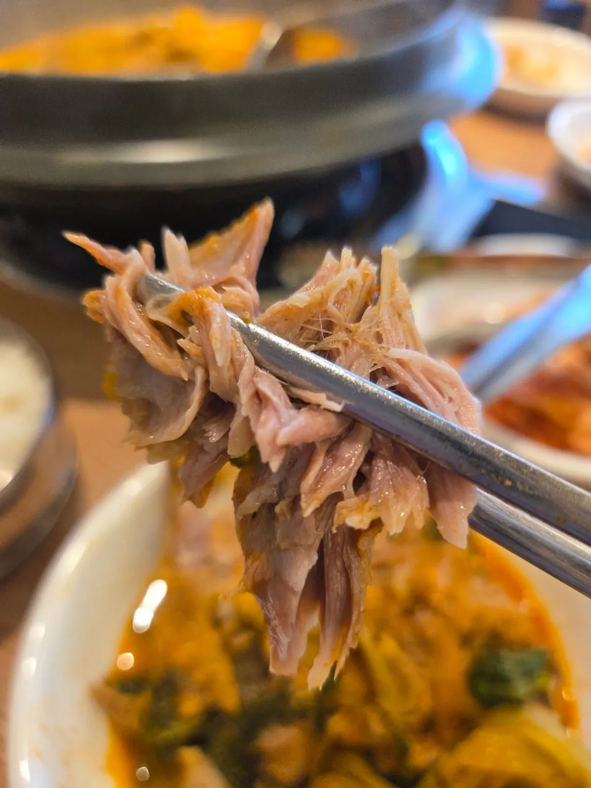 Rich broth simmering in the gamjatang pot