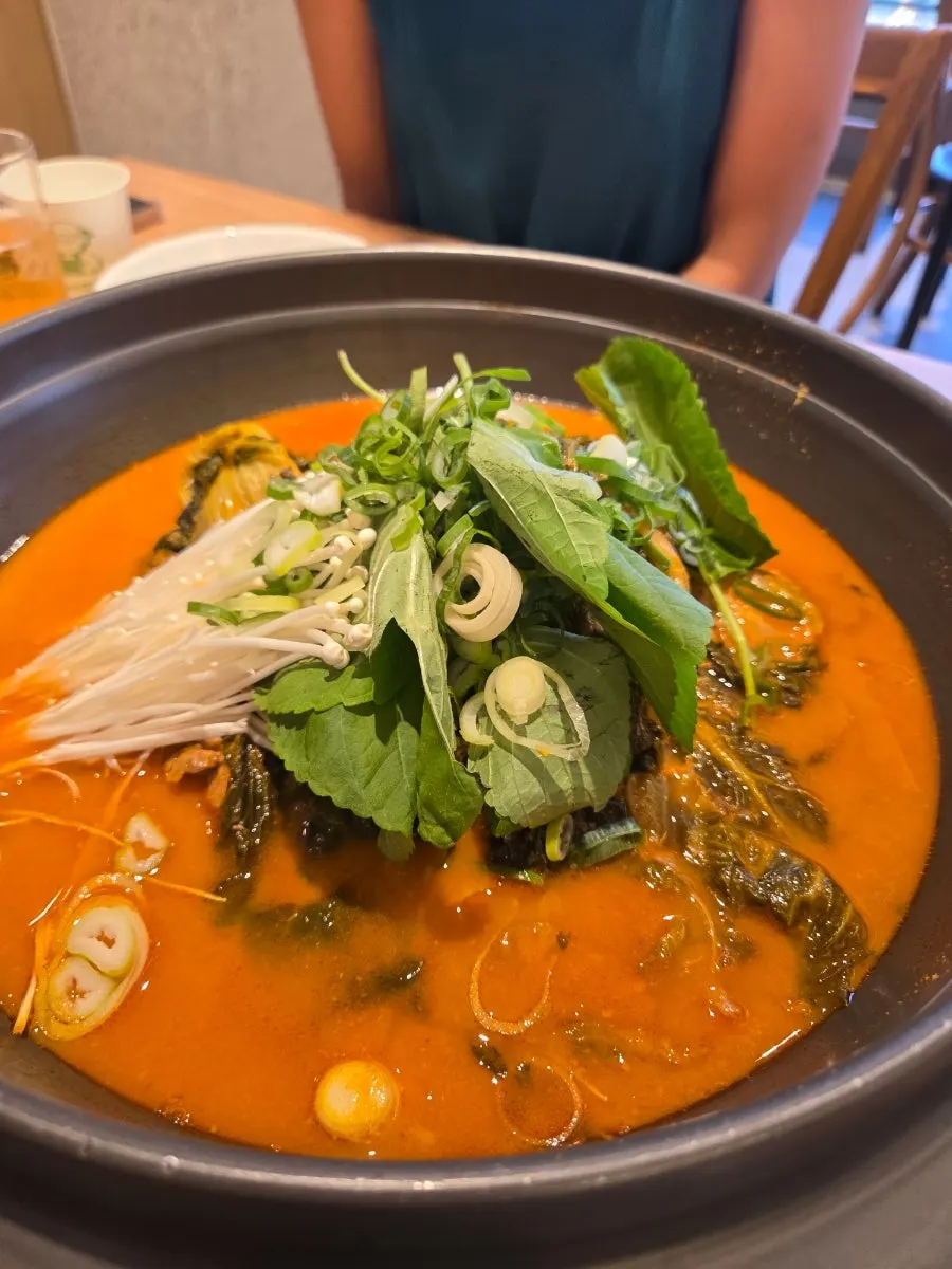 Radish greens and meat piled on rice