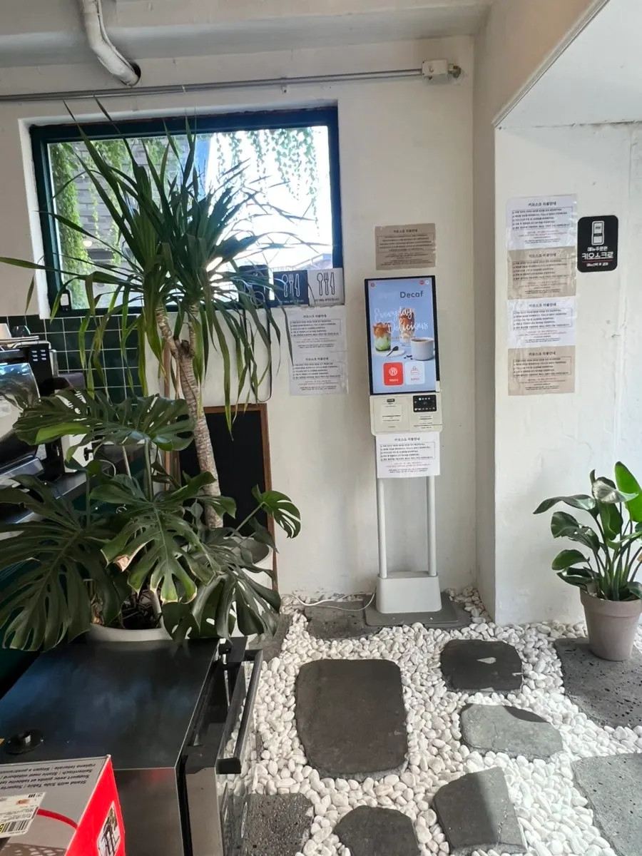 Restaurant entrance with a white pebble path