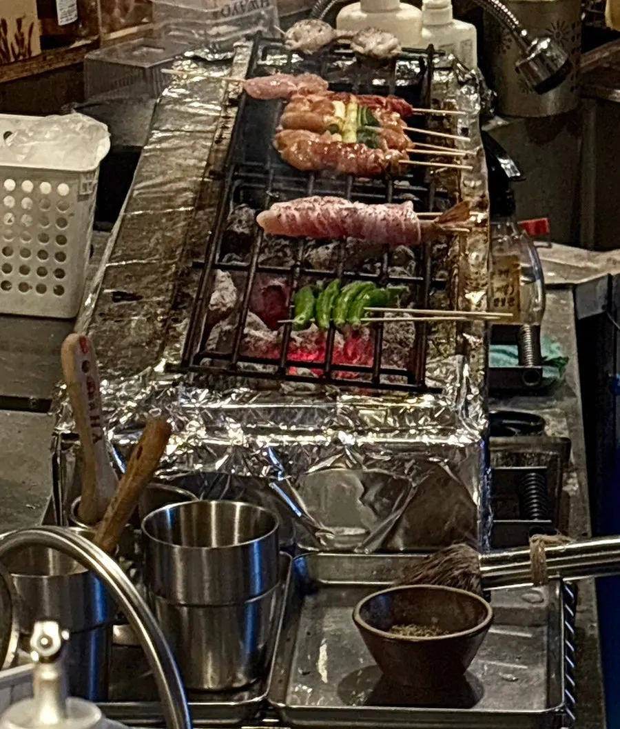 View of yakitori being grilled from the counter seats
