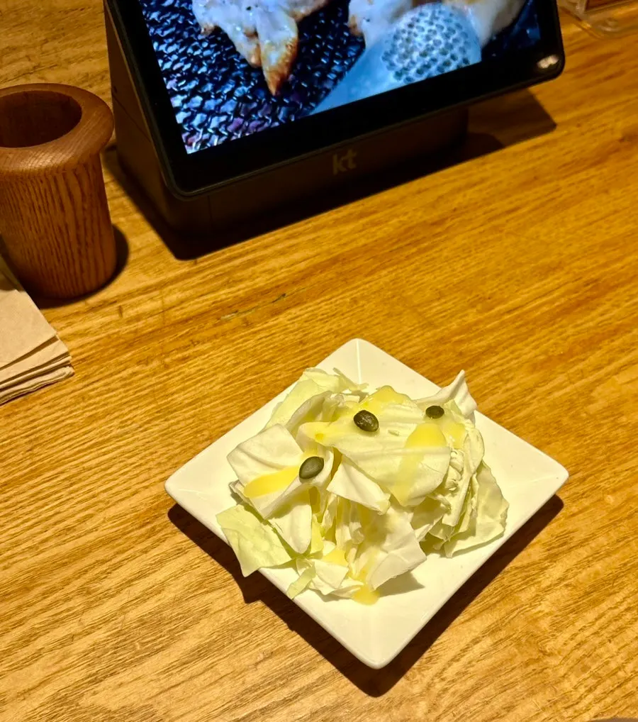 Complimentary cabbage salad served as a starter