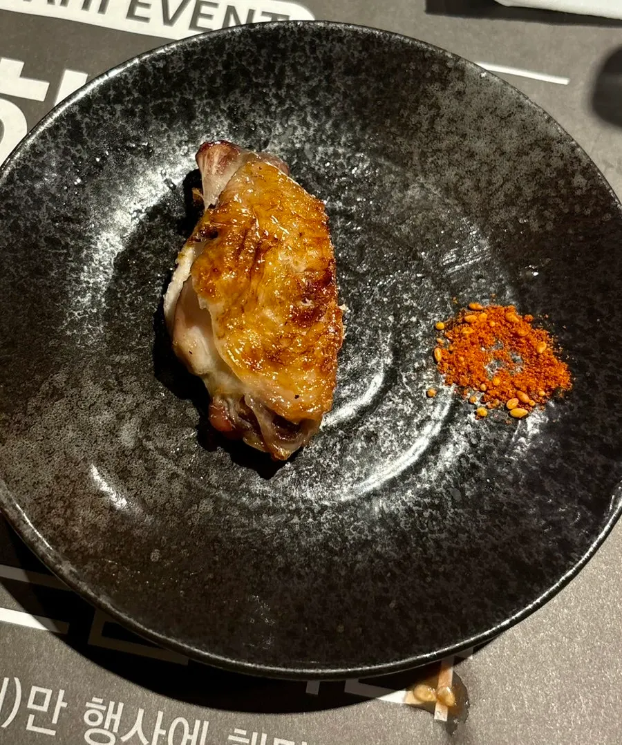 A yakitori skewer dipped in shichimi