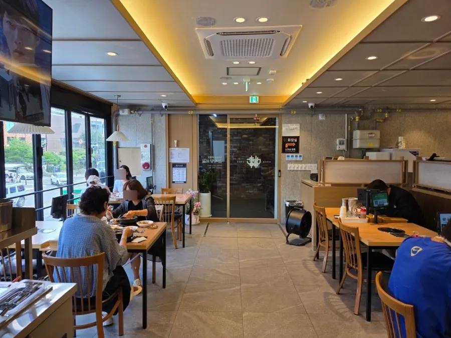 Tables set near the window inside the restaurant