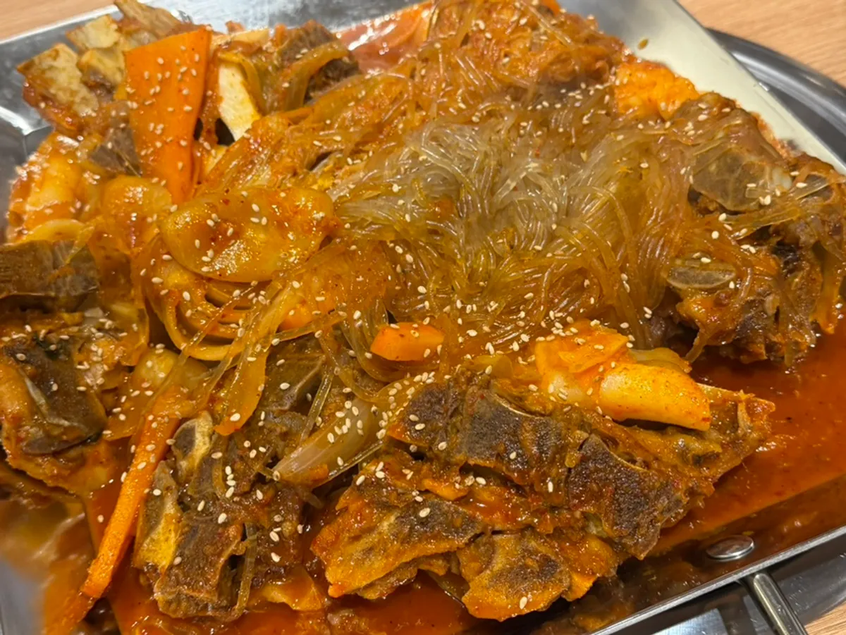 Gamjatang broth served alongside the bone stew