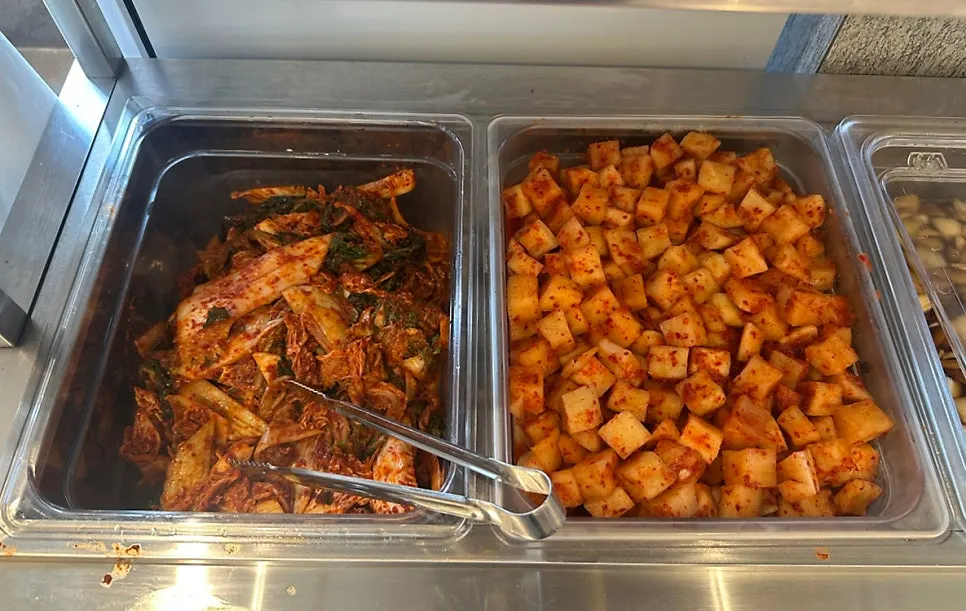 Self-serve side dish bar with fresh kimchi and radish kimchi