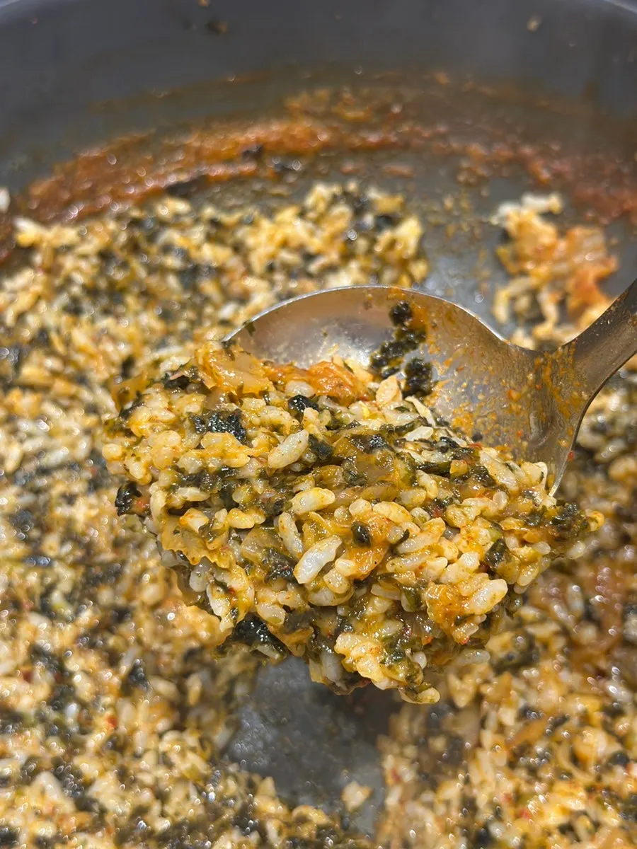 A pot filled to the brim with two servings of self-fried rice