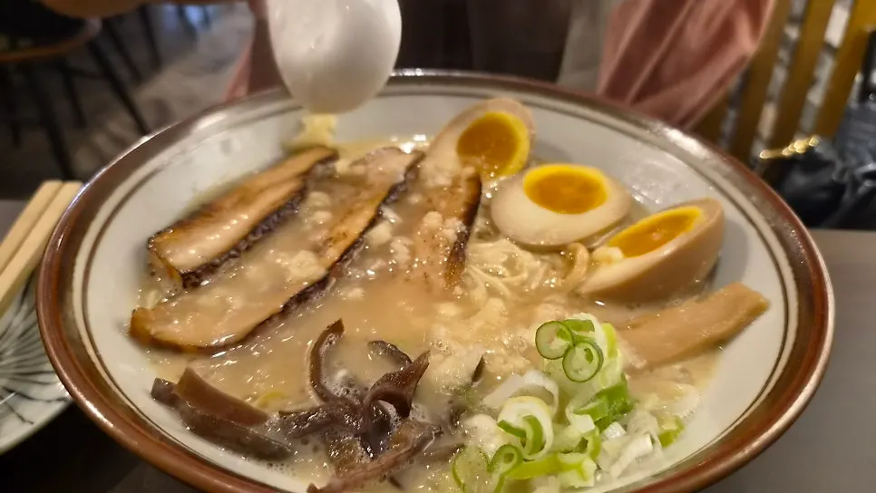 Umakara tonkotsu and tonkotsu ramen with all toppings added