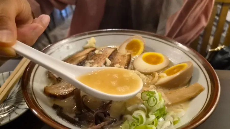 Close-up of tonkotsu ramen broth and chashu