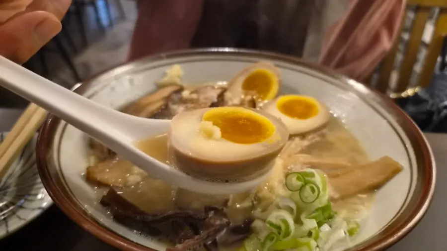 Noodles lifted up from the tonkotsu ramen bowl