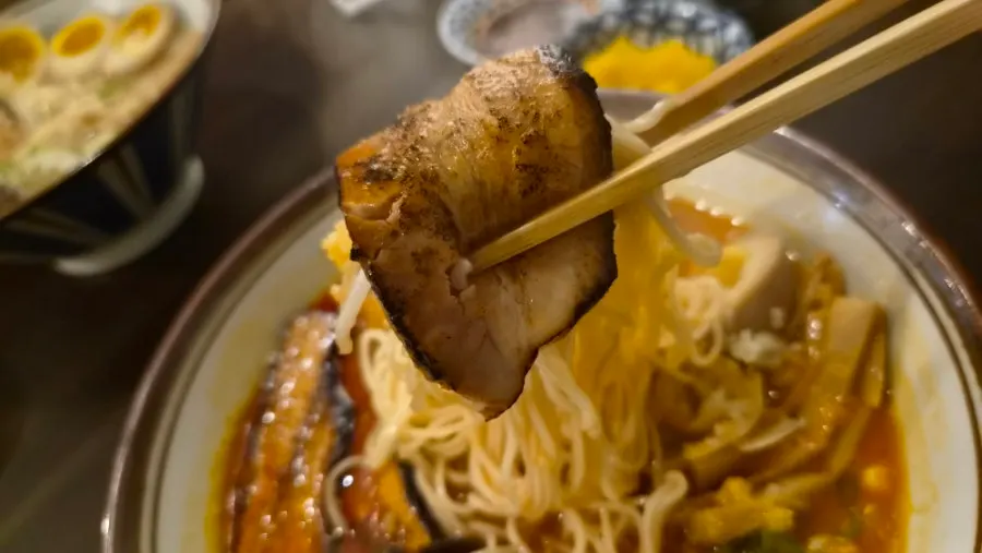 Noodles lifted from the spicy umakara tonkotsu