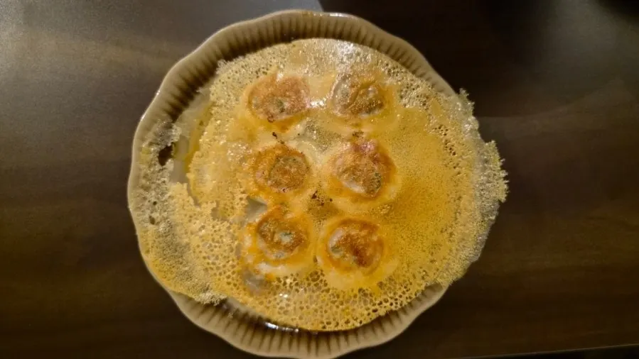 Bite-size gyoza pan-fried to a golden crisp on the bottom