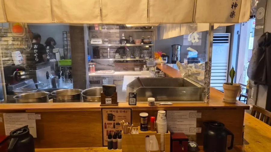 Interior of Okagura Ramen filled with customers