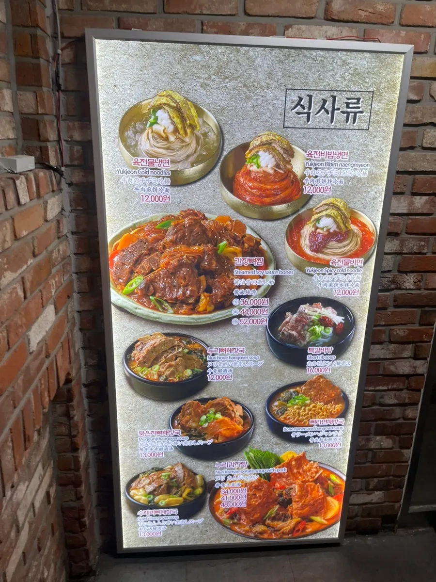 계단 위 매장 입구와 메뉴 사진 안내판