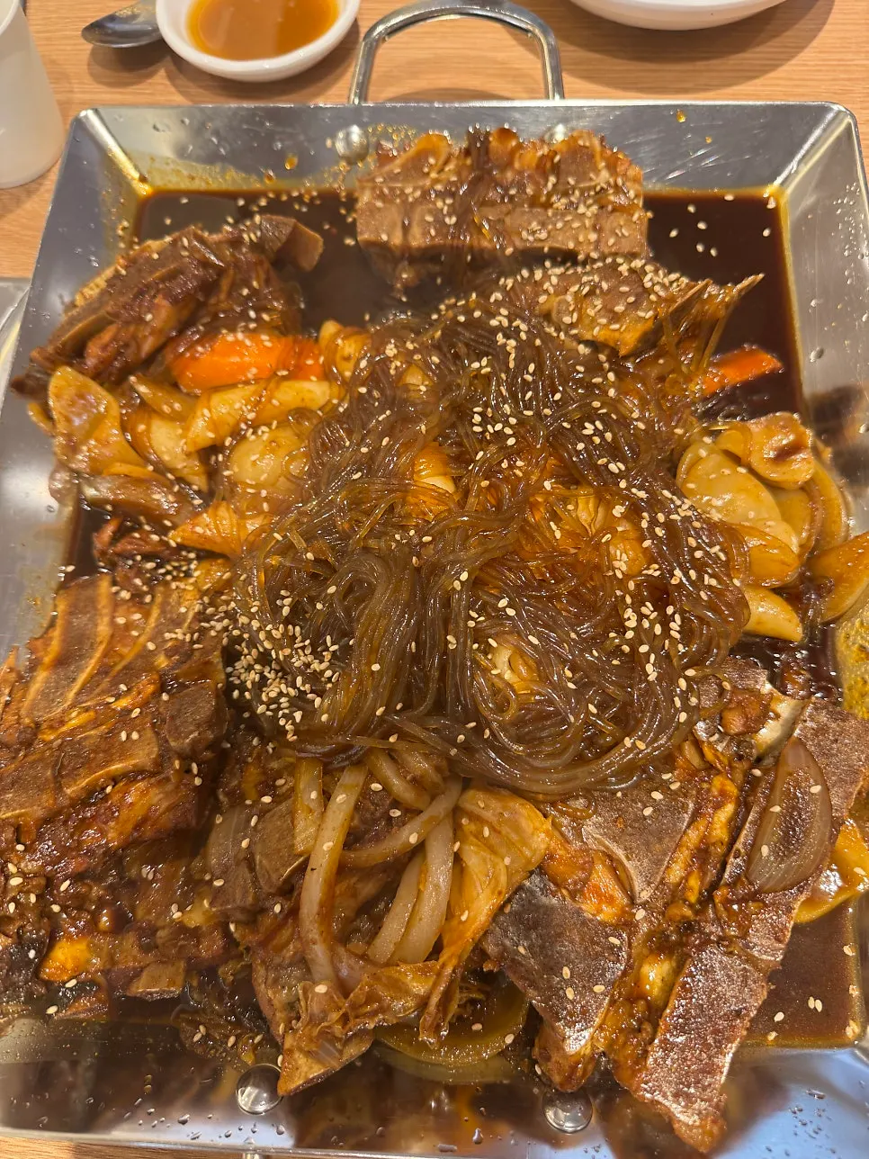 Soy-braised bone stew with back bones, glass noodles, sujebi, and rice cakes