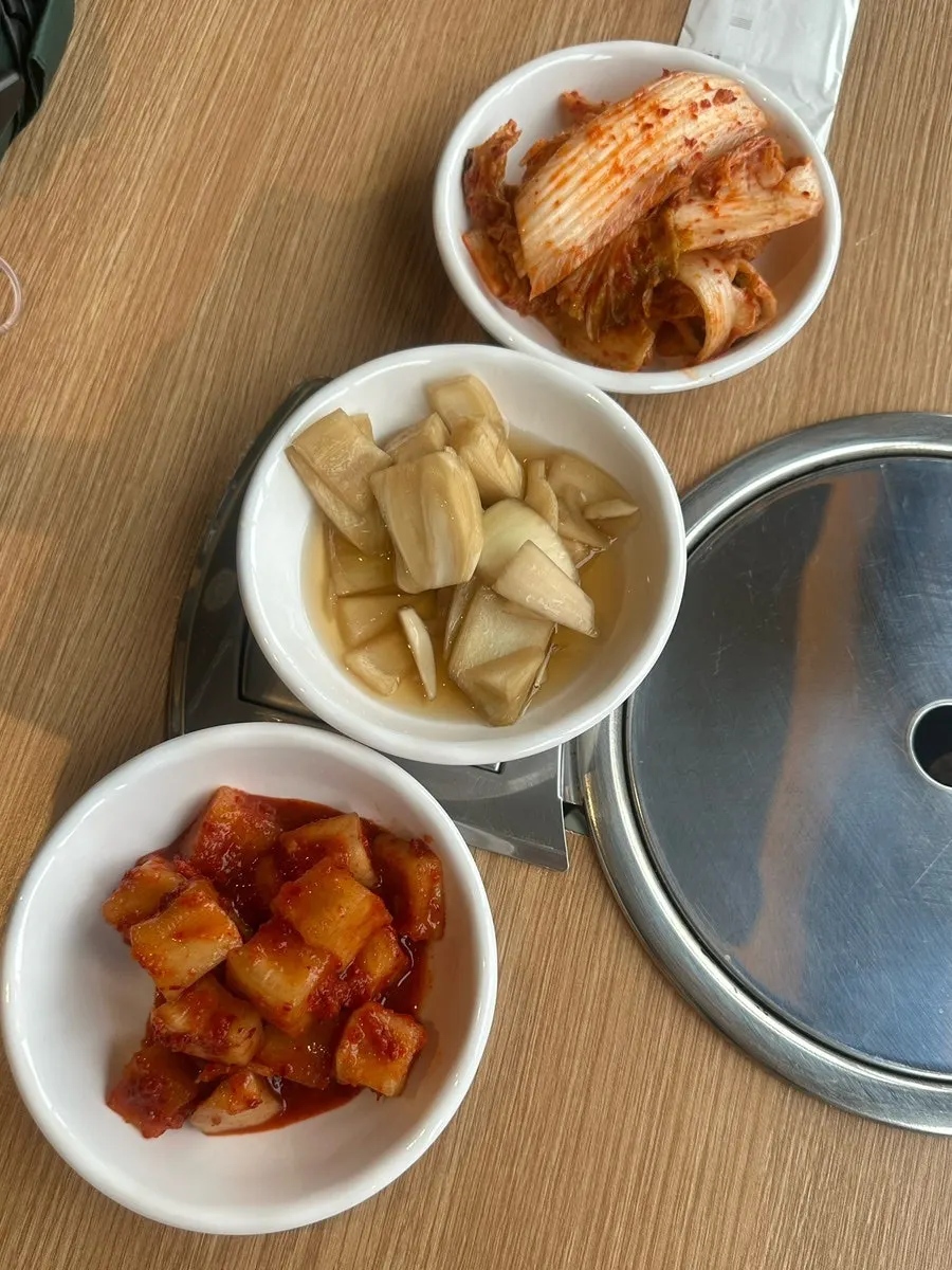 Basic side dishes: spicy peppers, pickled onions, kimchi, and cubed radish kimchi
