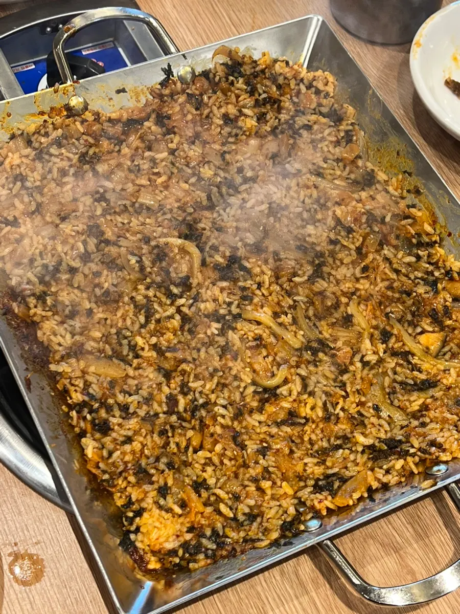 Fried rice cooked in sauce on the hot plate