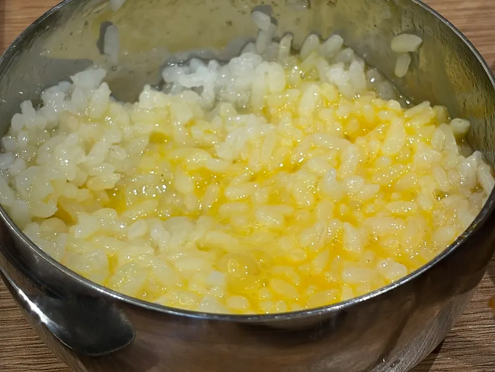 Raw egg mixed into rice alongside meat king dumplings
