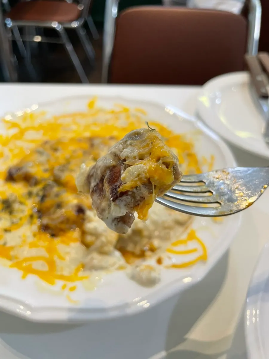 Stretchy melted cheese on the pork neck cream risotto