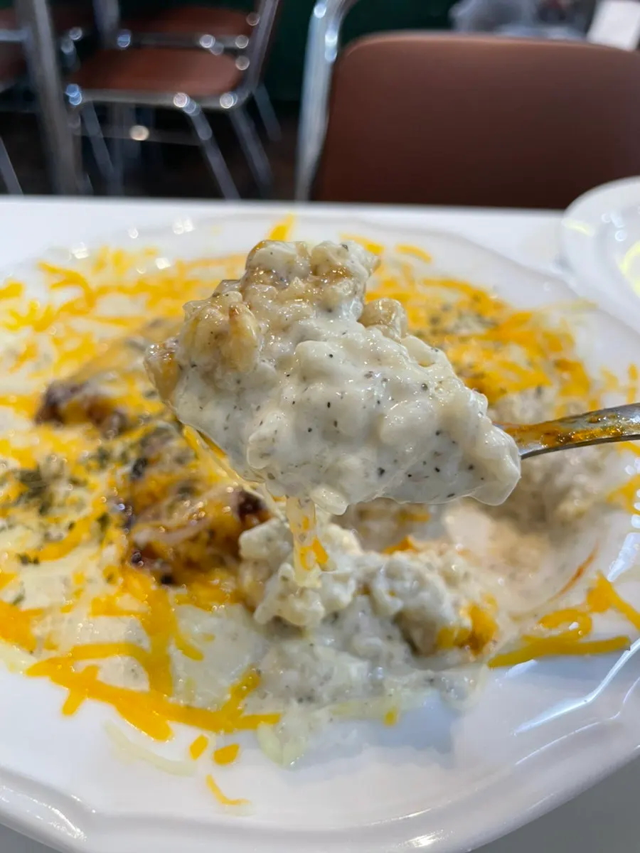 Close-up of the pork neck topping on the cream risotto