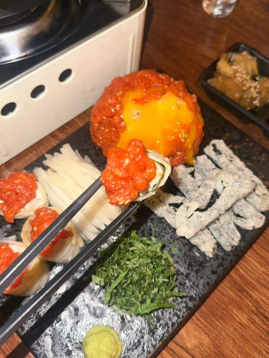 Plate of red yukhoe topped with egg yolk