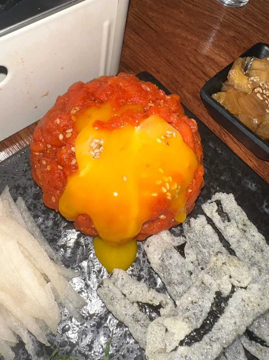 Yukhoe served over aged kimchi