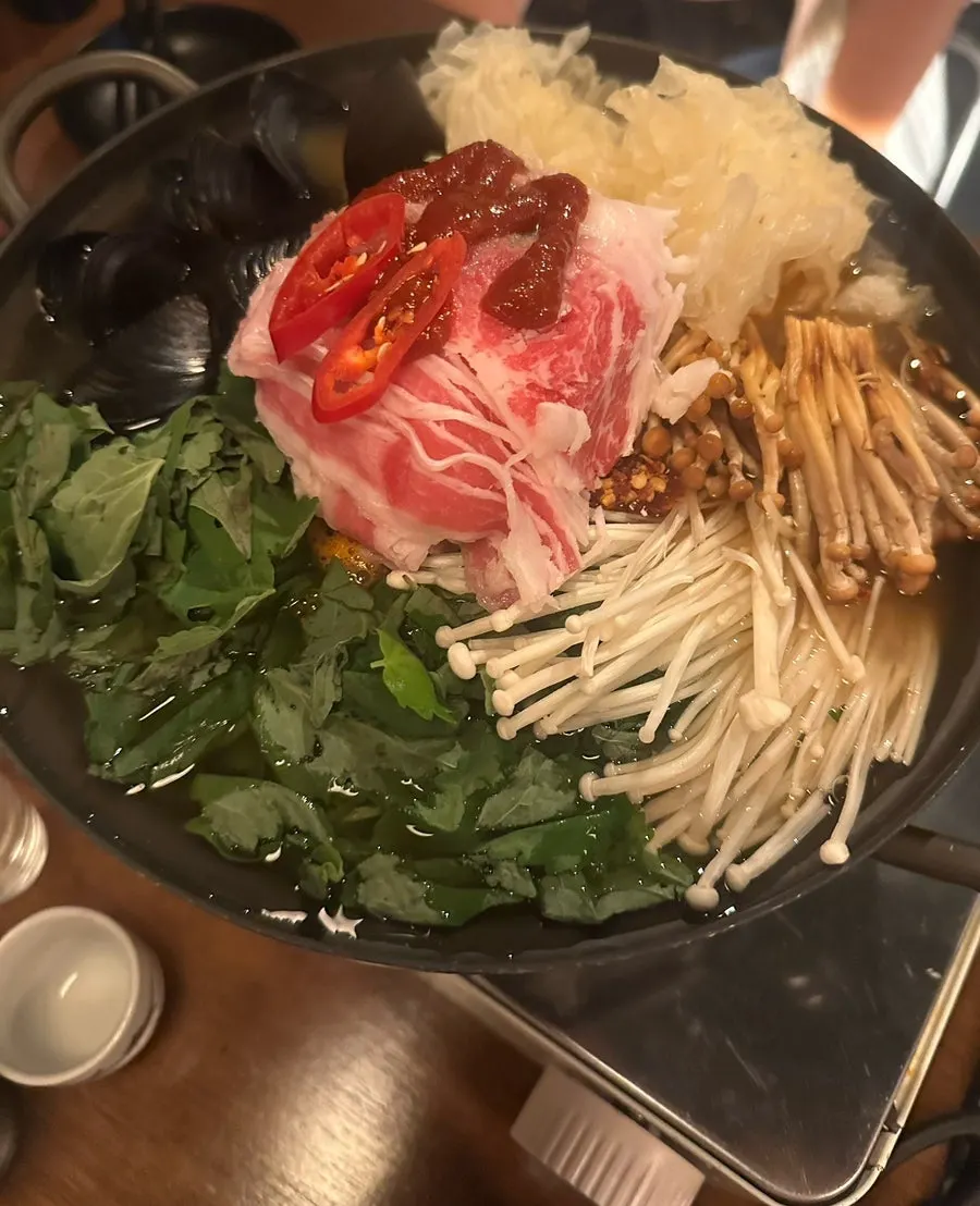 Pot of spicy numbing hotpot set in the middle of the table