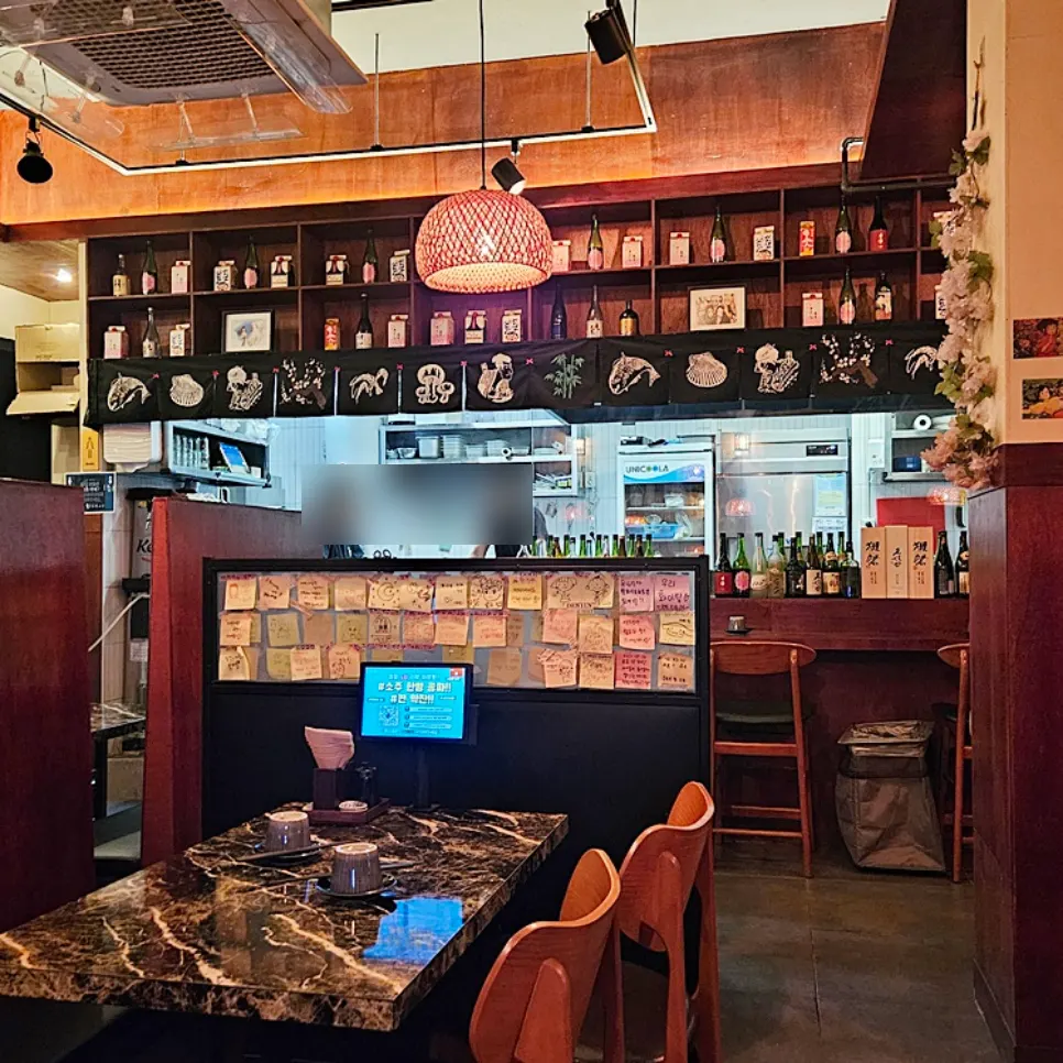 Softly lit table area inside Ito izakaya