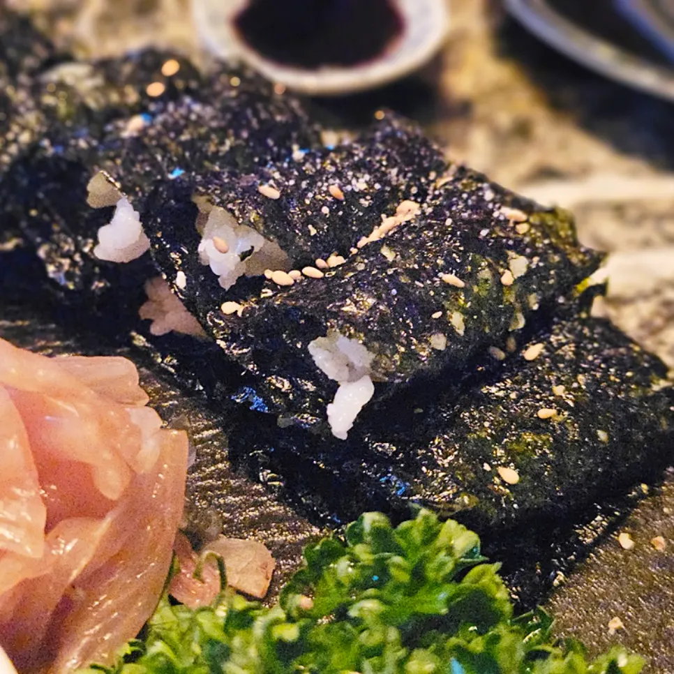 Plate of halibut salt gimbap sprinkled with sesame seeds