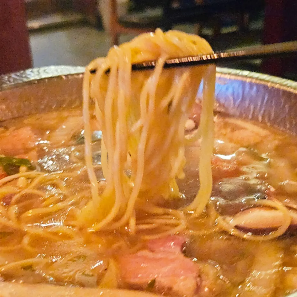 Fresh noodles added to the mizutaki pot