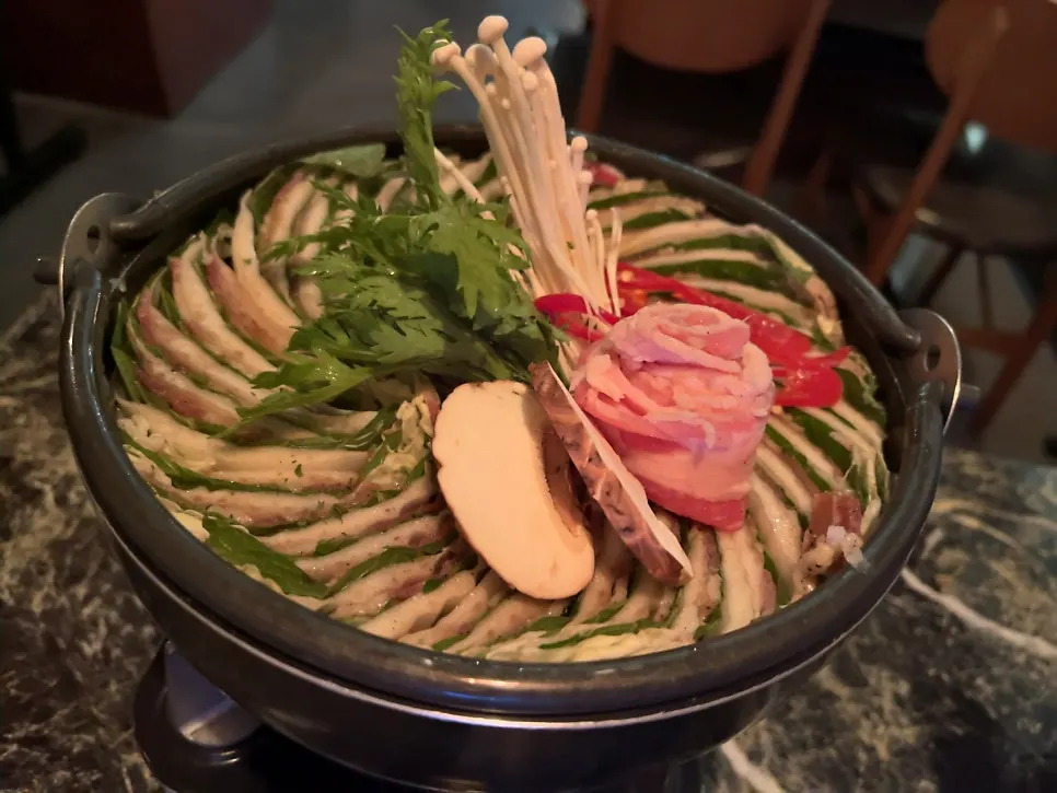 Layers of napa cabbage and beef in the mille-feuille nabe